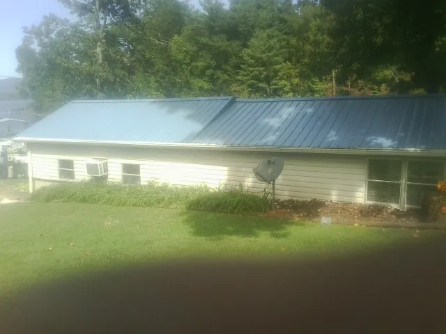 Blue metal roof running the length of a single story home in Spring Arbor